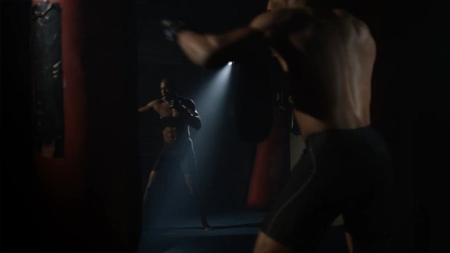  MMA fighter training in front of mirror at the gym