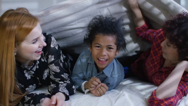  Gay female couple relaxing in bed get taken by surprise by young son