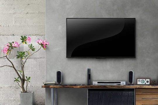 Led tv on concrete wall with wooden table in living room