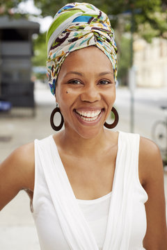 Black woman smiling on city street