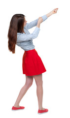 back view of standing girl pulling a rope from the top or cling to something. girl  watching. Rear view people collection.  backside view of person.  Isolated over white background. Long-haired