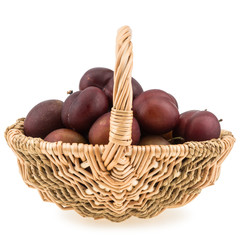 Obraz premium Sweet Plums in the wicker basket isolated on white background.