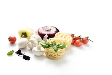 white pasta and fresh basil, mushrooms, cherry tomatoes, onions, peppers on a white background