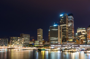 Circular Quay wharf with Sydney skyline at dusk. Modern cityscape and infrastructure, NSW, Australia