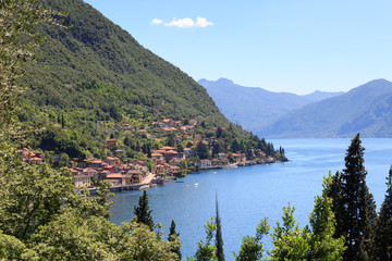 Fototapeta na wymiar Panorama of lakeside village Fiumelatte at Lake Como with mountains in Lombardy, Italy