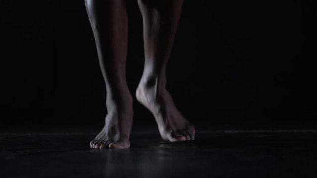  Unrecognizable MMA fighter training with skipping rope in dark environment