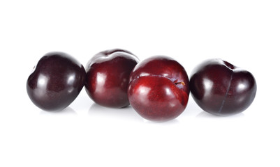 whole ripe plum on white background