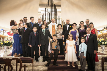 Family posing at wedding in church