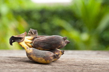Bunch of over ripe bananas on wood and background nature
