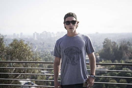 Caucasian man near railing overlooking scenic view of city