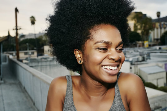 Black Woman Smiling On Urban Rooftop