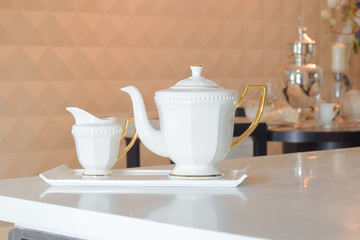 White ceramic tea set on white top dining table