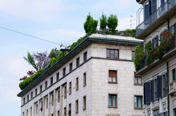 Fototapeta na wymiar white houses with green roofs of Milan