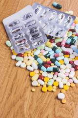 pills and empty blister pack on to surface wooden