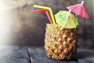 pineapple with straw and cocktail umbrella - obrazy, fototapety, plakaty