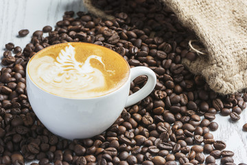 A cup of hot latte with Coffee bean