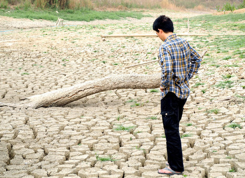 The farmer standing on mud crack in dry season
