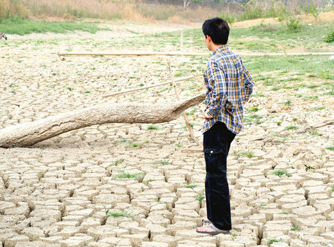The farmer standing on mud crack in dry season