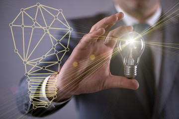 Young businessman with light bulb in idea concept