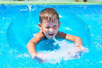 Fototapeta na wymiar Boy swimming into pool