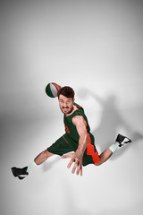 Obraz na płótnie Canvas Full length portrait of a basketball player with ball