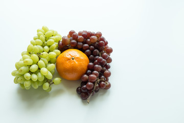 Oranges and grapes on white background