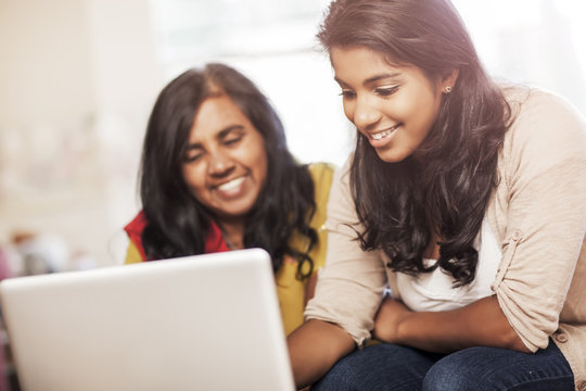 Indian Mother And Daughter Using Laptop Together