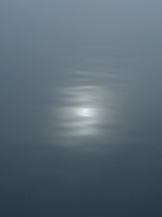 sun glare on the water in a dense fog