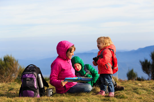 Mother With Two Kids Hiking In Mountains