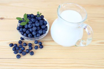 Blueberry on wooden background. Blueberry close up and blueberry background. Berries closeup. Blueberry with milk