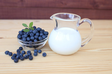 Blueberry on wooden background. Blueberry close up and blueberry background. Berries closeup. Blueberry with milk