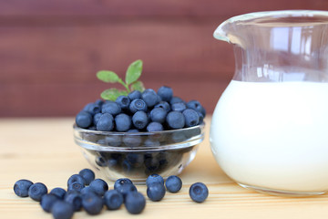 Blueberry on wooden background. Blueberry close up and blueberry background. Berries closeup. Blueberry with milk