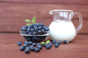 Blueberry on wooden background. Blueberry close up and blueberry background. Berries closeup. Blueberry with milk