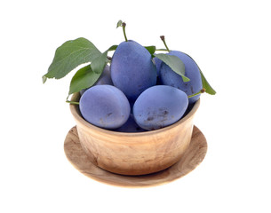  Delicious blue plums in a wooden bowl, selective focus,isolated white background.