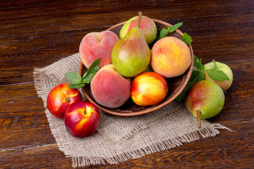 peaches, nectarines and pears - summer fruit on wooden background
