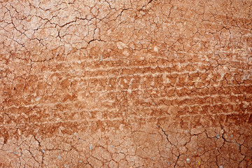 Tire tracks on the road gravel stone background