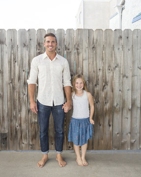 Caucasian father and daughter holding hands outdoors