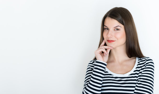 Attractive young woman deep in her thoughts, on white background