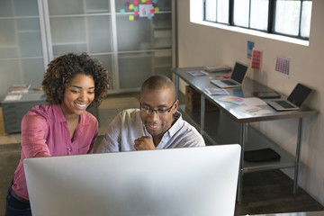 Business people using computer in office
