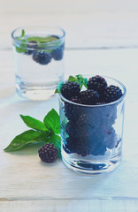 Fototapeta na wymiar blackberries in a glass on a white background