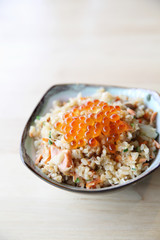 Fototapeta na wymiar Japanese Cuisine Fried Rice with salmon and caviar on top