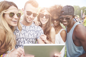 Digital tablet held by young people.