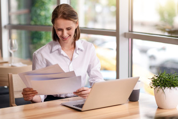 Cheerful woman working with papers