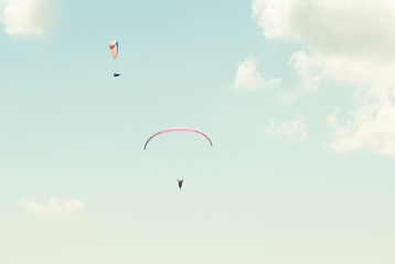 Two paraglider in the sky in sun light