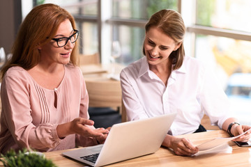 Cheerful colleagues sitting at the table