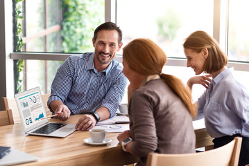 Cheerful colleagues discussing project