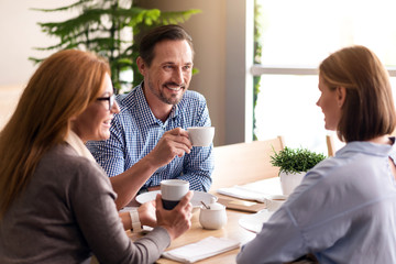 Cheerful smiling colleagues having lunch