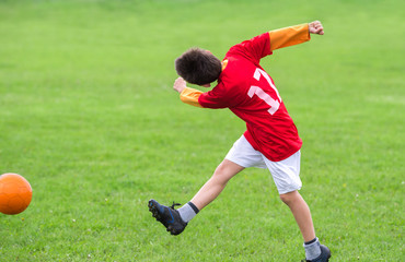 Kid kicking a soccer ball