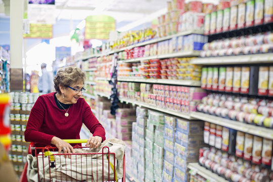 Senior Hispanic woman shopping in grocery store