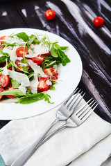 Close-up shot of tomatoes and arugula salad